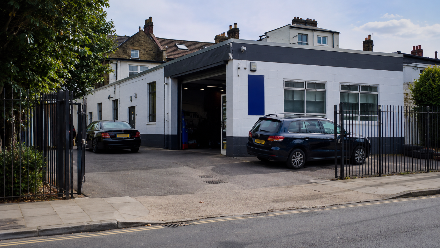 Automotive garage exterior with parked vehicles